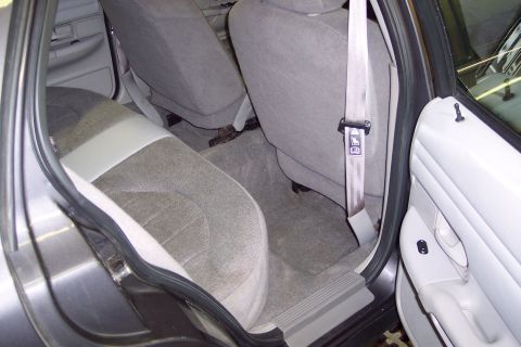 2001 Ford Crown Victoria - The interior of a 2001 Ford Crown Victoria shows the rear seats and door panel.