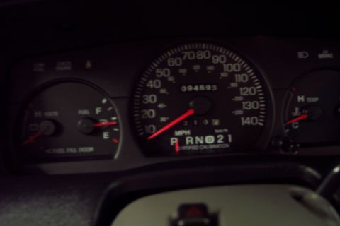 2001 Ford Crown Victoria - The car's odometer reads 94,693 miles and the gear selector is in Park.