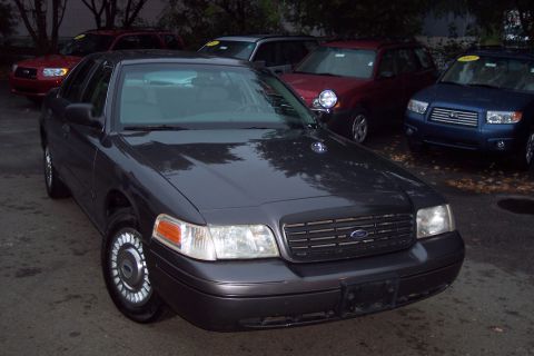 2001 Ford Crown Victoria - This 2001 Ford Crown Victoria is shown from a 3q-front angle, with other vehicles visible in the background.