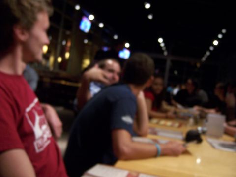 1991 Ford Bronco - A group of friends are gathered around a table, possibly at a restaurant or bar.