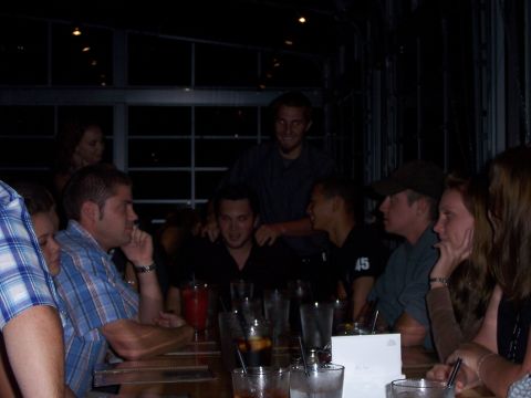 1991 Ford Bronco - A group of friends gather around a table, enjoying drinks and conversation at an indoor venue.