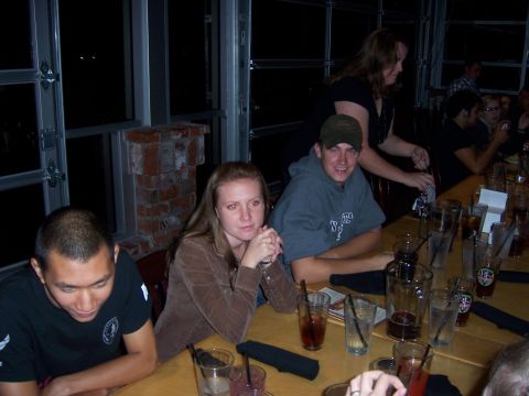 1991 Ford Bronco - A group of friends gather around a table, enjoying drinks and conversation in a dimly lit setting.