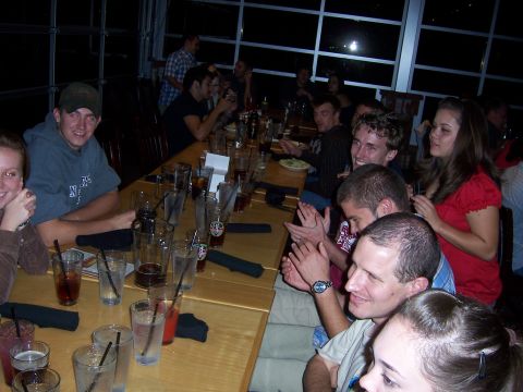 1991 Ford Bronco - A group of friends enjoys a gathering around a long table, with drinks and food visible.