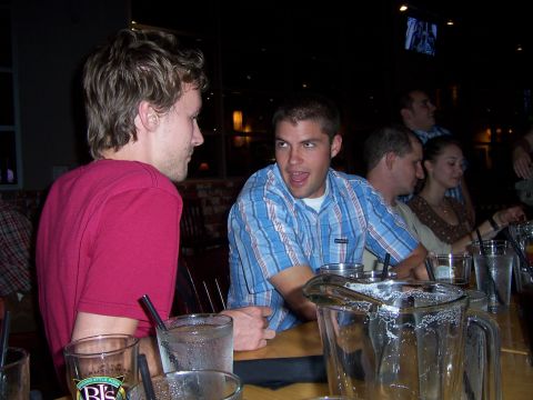 1991 Ford Bronco - People gathered at a bar, engaged in conversation over drinks.