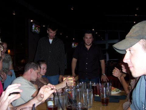 1991 Ford Bronco - A group of friends are celebrating at a table, with drinks and a gift in the center.