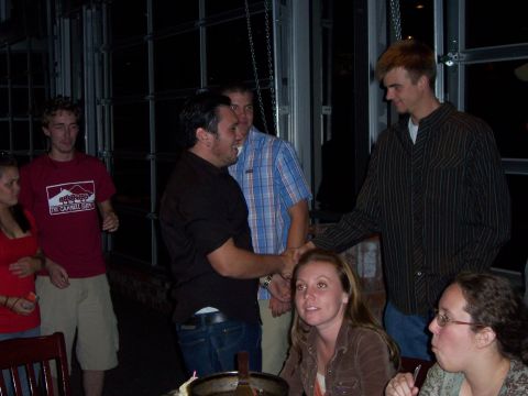 1991 Ford Bronco - A group of friends are socializing at an indoor event.
