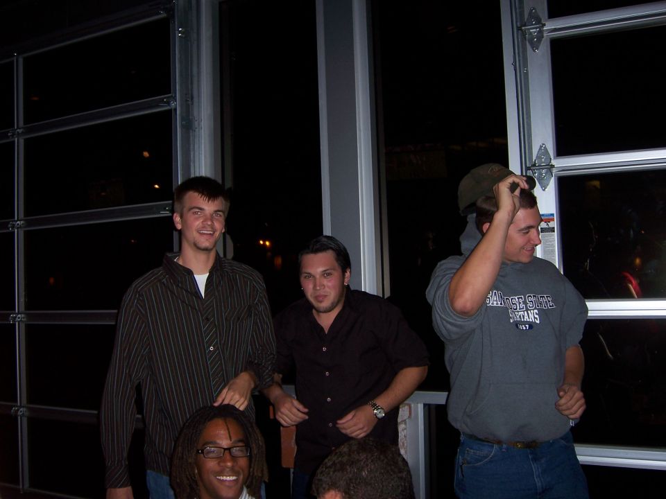 Group of young men posing for a photo indoors