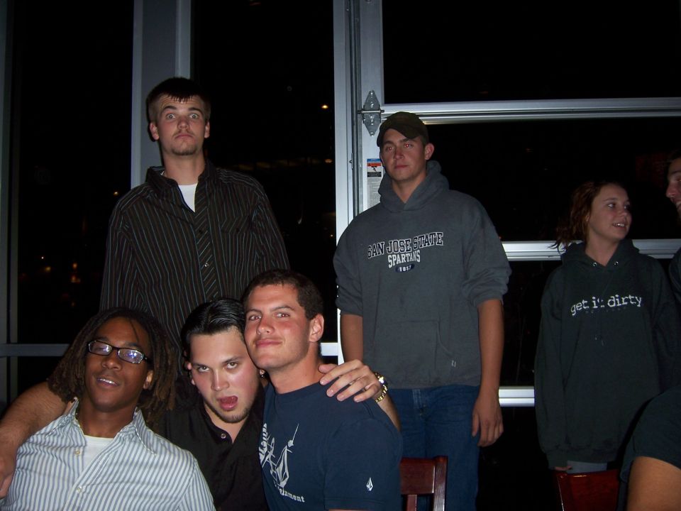 group of friends posing for a photo indoors, one wearing a San Jose State hoodie