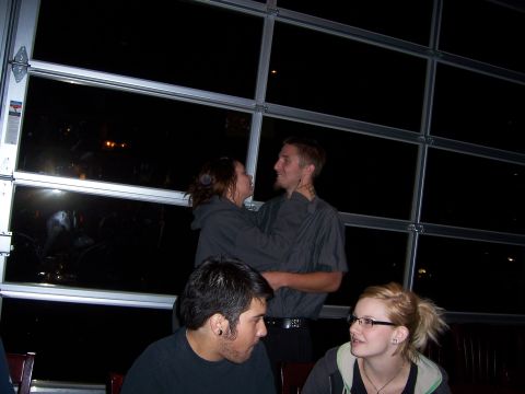 1991 Ford Bronco - A group of friends are seen indoors, with large windows behind them reflecting the dark night sky.