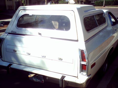 1973 Ford Ranchero - Rear view of a white 1973 Ford Ranchero pickup truck, equipped with a camper shell.