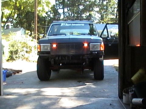 1990 Ford Bronco - Front view of a 1990 Ford Bronco with its door open, parked in a driveway.