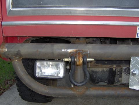 1978 Ford Bronco - Close-up of a custom rear bumper a heavy-duty tow shackle and a rectangular auxiliary light.