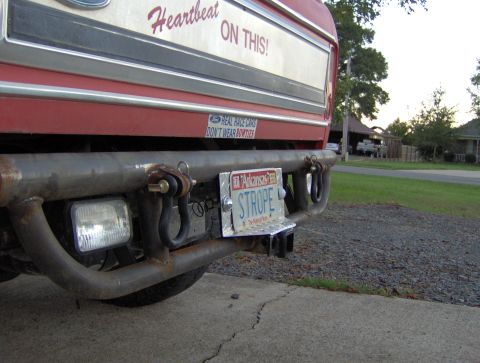 1978 Ford Bronco - A custom-built rear bumper with integrated tow hitch and shackle mounts is attached to a red vehicle.