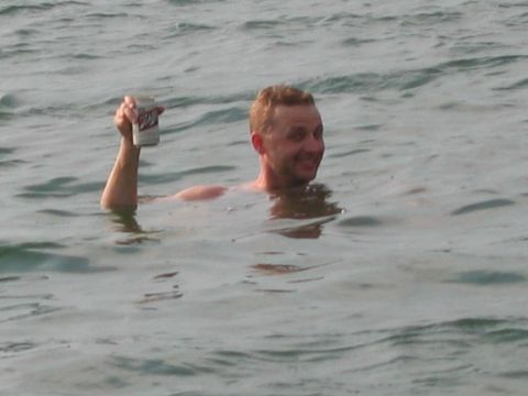 1985 Ford LTD Crown Victoria - Man holding a can while swimming in the water at Lake Hartwell, SC.