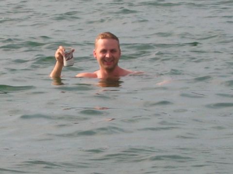 1985 Ford LTD Crown Victoria - A man enjoys a beverage while swimming in Lake Hartwell, South Carolina on August 24, 2007.