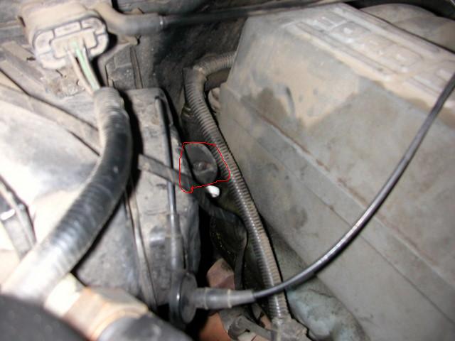 Engine bay with wiring and a plastic cover