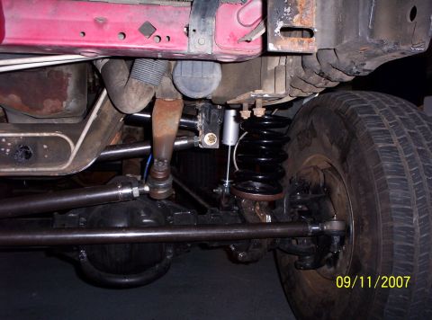 1995 Ford Bronco - Close-up view of suspension components and a tire on a red vehicle, with a date stamp from 2007.