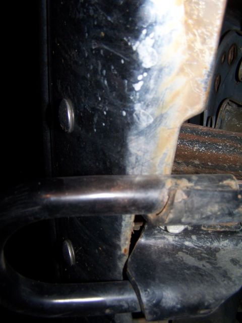 1990 Ford Bronco - A close-up view of a vehicle's tow hook, showing its mounting hardware and some rust.