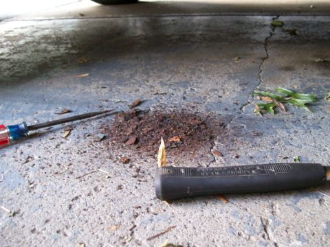 1995 Mercury Grand Marquis - Tools and debris are visible on the ground underneath a vehicle, suggesting recent work or maintenance.