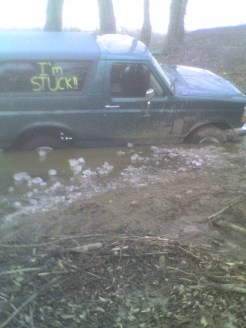 1996 Ford Bronco - This 1996 Ford Bronco is stuck in the mud, with the message "I'M STUCK!!" clearly visible on its window.