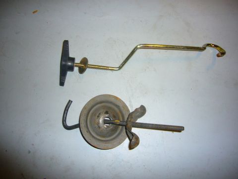 2000 Ford Crown Victoria - Two parts that appear to be from a car jack are laid out on a flat surface.