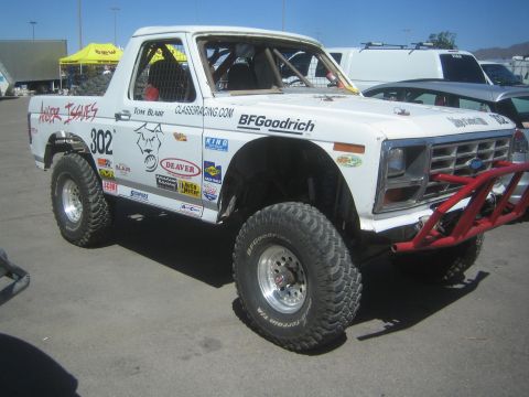 1990 Ford Bronco - white full-size Ford Bronco off-road race truck numbered 302 with a red tube bumper, BFGoodrich and Class3Racing.com livery.