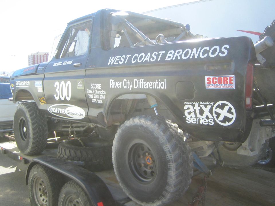 Black Ford Bronco race truck #300 lettered West Coast Broncos on trailer