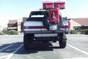 1991 Ford Bronco - Rear view of a 1991 Ford Bronco, parked in a lot on a sunny day.