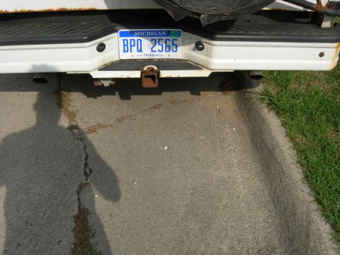 1996 Ford Bronco - The rear of a white vehicle is shown, a license plate and trailer hitch.