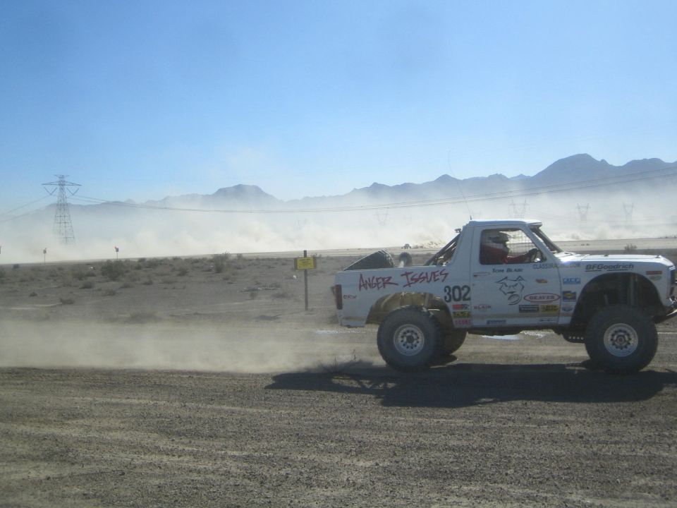 White Anger Issues race truck 302 speeding on a desert track
