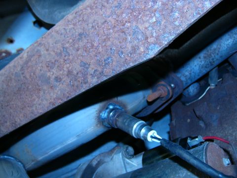 1996 Ford Bronco - Close-up of an exhaust pipe with a newly installed oxygen sensor and visible wiring.