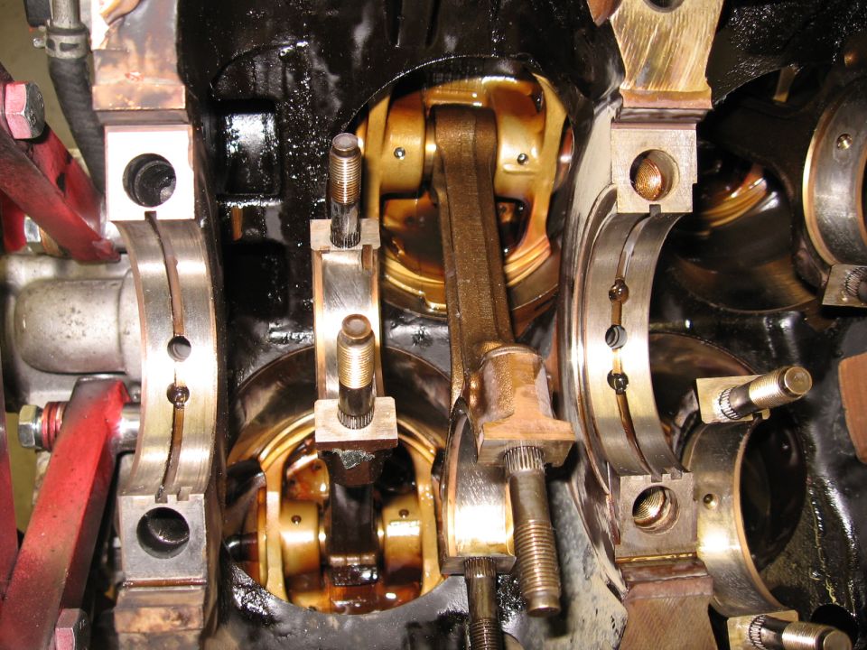 Engine crankshaft and pistons with connecting rods and bearing caps