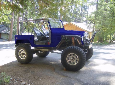 1989 Ford Bronco - This heavily modified vehicle features a custom roll cage and oversized tires, suggesting it's built for off-road use.