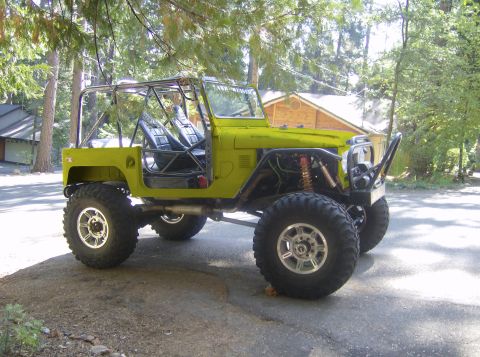 1989 Ford Bronco - This heavily modified Jeep features a roll cage, off-road tires, and exposed engine components.