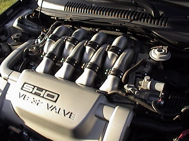 Close-up of a Ford SHO V6 engine with 'SHO V6 24 VALVE' visible on the intake manifold