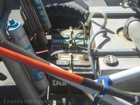 1990 Ford Bronco - Detail of a race vehicle showing Interstate batteries, King coilover shocks, a fuel cell and routed hoses behind the cab.