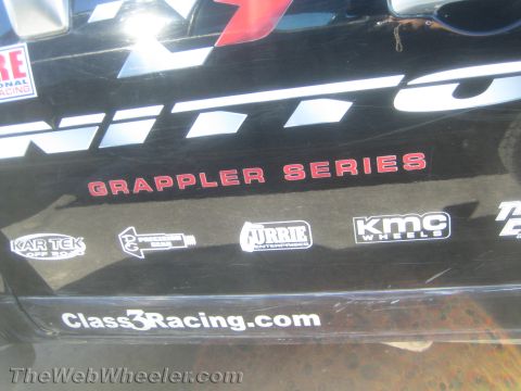 1990 Ford Bronco - Black tailgate of an off-road truck displaying Nitto Grappler Series graphics, Class3Racing.com and sponsor decals including KMC and Currie.