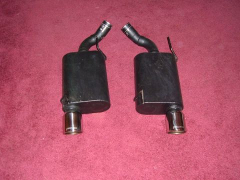 2007 Ford Mustang - Two black mufflers with chrome tips are shown, likely aftermarket parts for a vehicle.