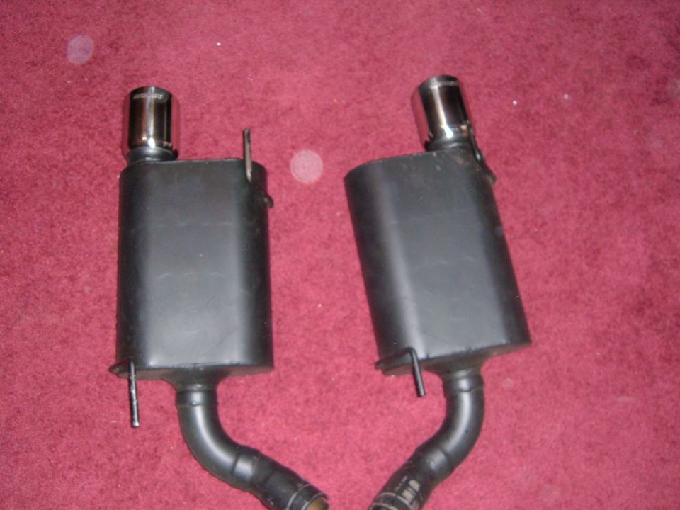 pair of black exhaust mufflers with chrome tips