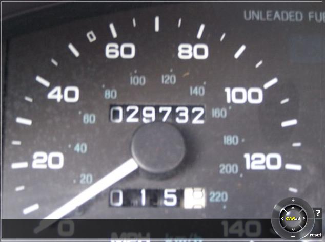 Car dashboard showing a speedometer reading 20 MPH and an odometer reading 029732. The fuel gauge shows empty