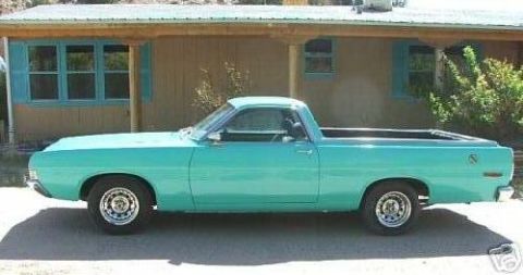1968 Ford Ranchero - This turquoise pickup truck, likely a 1969 model, is shown from the side in front of a building.