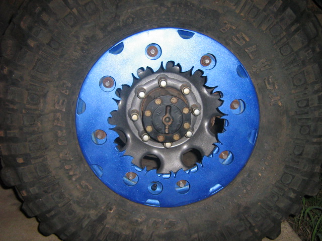 Blue steel wheel on a Super Swamper mud tire with eight-lug manual locking hub