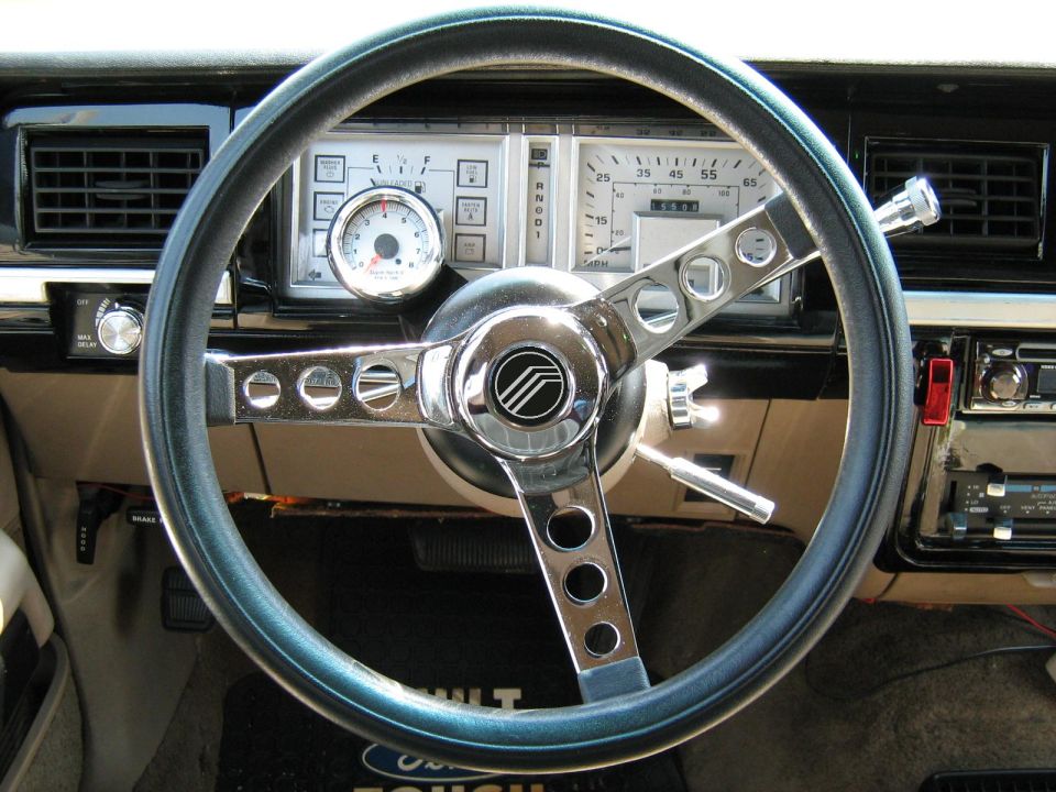 1988 Mercury Grand Marquis interior showing aftermarket steering wheel and dashboard gauges