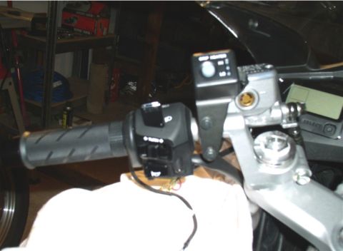1990 Ford Bronco - Detail of motorcycle handlebar controls, including grip, turn signal switch, and brake master cylinder.