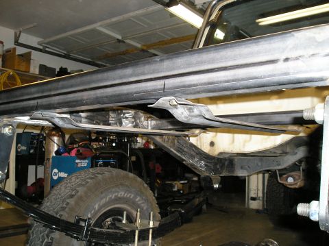 1986 Toyota Hilux - Close-up view of the undercarriage, focusing on the suspension and frame of a truck.
