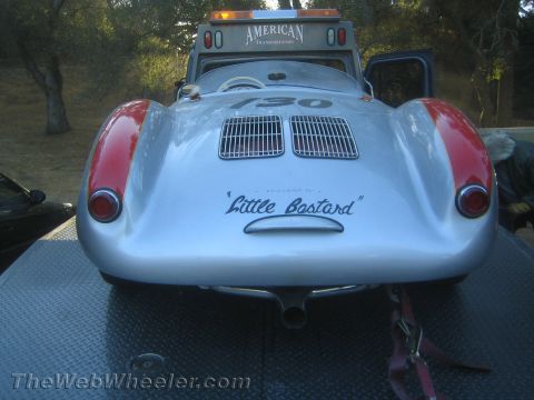 1990 Ford Bronco - rear of a silver spyder race car numbered 130 bears the script "Little Bastard" while loaded on a flatbed truck.
