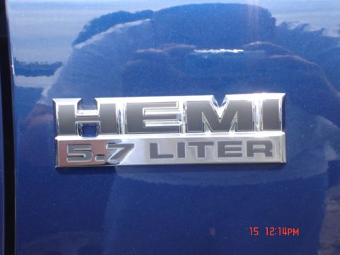 1981 Ford Bronco - Close-up of a HEMI 5.7 LITER badge affixed to a blue vehicle's exterior.