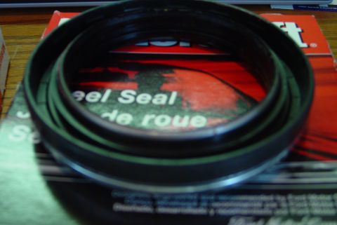1993 Ford Bronco - A wheel seal is shown resting on its product packaging.