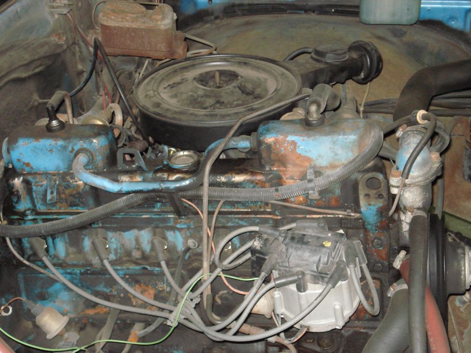 Close-up of a V8 engine with blue painted valve covers and a black air cleaner