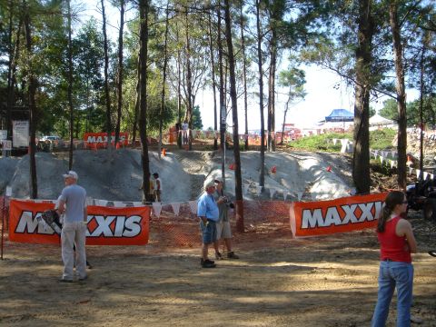 2002 Jeep Wrangler - Spectators gather at an outdoor off-road event, with prominent Maxxis banners visible around the course.